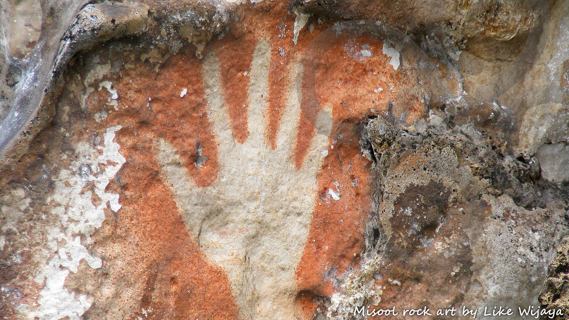 Rock art, including timeless so-called 'stencilled hands', off Misool Island in the fabled Raja Ampat archipelago off New Guinea's western tip, is being associated with the first wave of human expansion into the New Guinea region. Copyright &copy; Like Wijaya