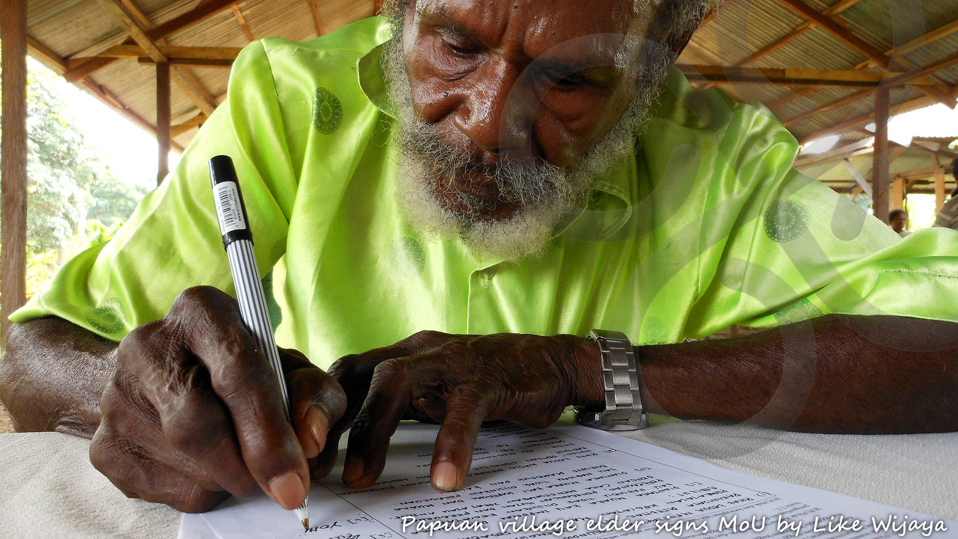 A Papuan village elder signs a Memory of Understanding with Papua Expeditions to deploy essentially non-invasive ecotourism activities on ancestral lands, thereby laying out the best possible framework for continuous visitation. Copyright &copy; Like Wijaya